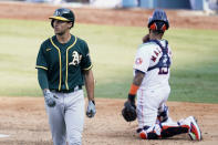 Oakland Athletics' Matt Olson, left, walks to the dugout after striking out against the Houston Astros during the eighth inning of Game 4 of a baseball American League Division Series in Los Angeles, Thursday, Oct. 8, 2020. At right is Astros catcher Martin Maldonado. (AP Photo/Marcio Jose Sanchez)