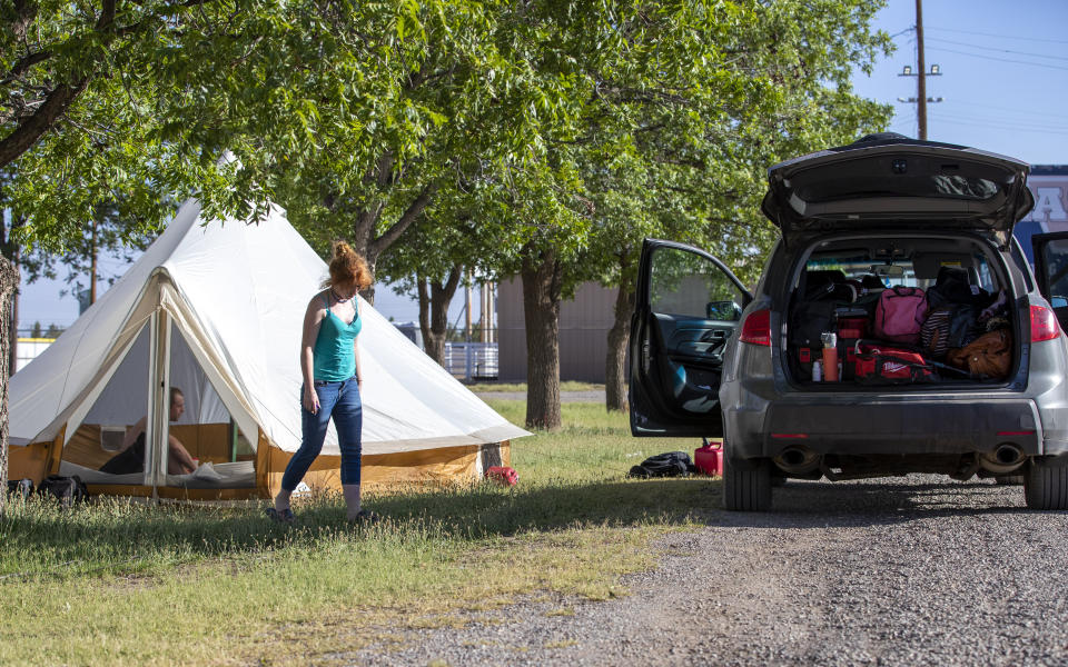 A couple from Ruidoso, N.M. camps at the Eastern New Mexico State Fairgrounds in Roswell, N.M., Wednesday, June 19, 2024. Strong wind pushed the larger of two wildfires into the mountain village of Ruidoso, forcing residents to flee. One person was killed and hundreds of structures were damaged. (AP Photo/Andres Leighton)