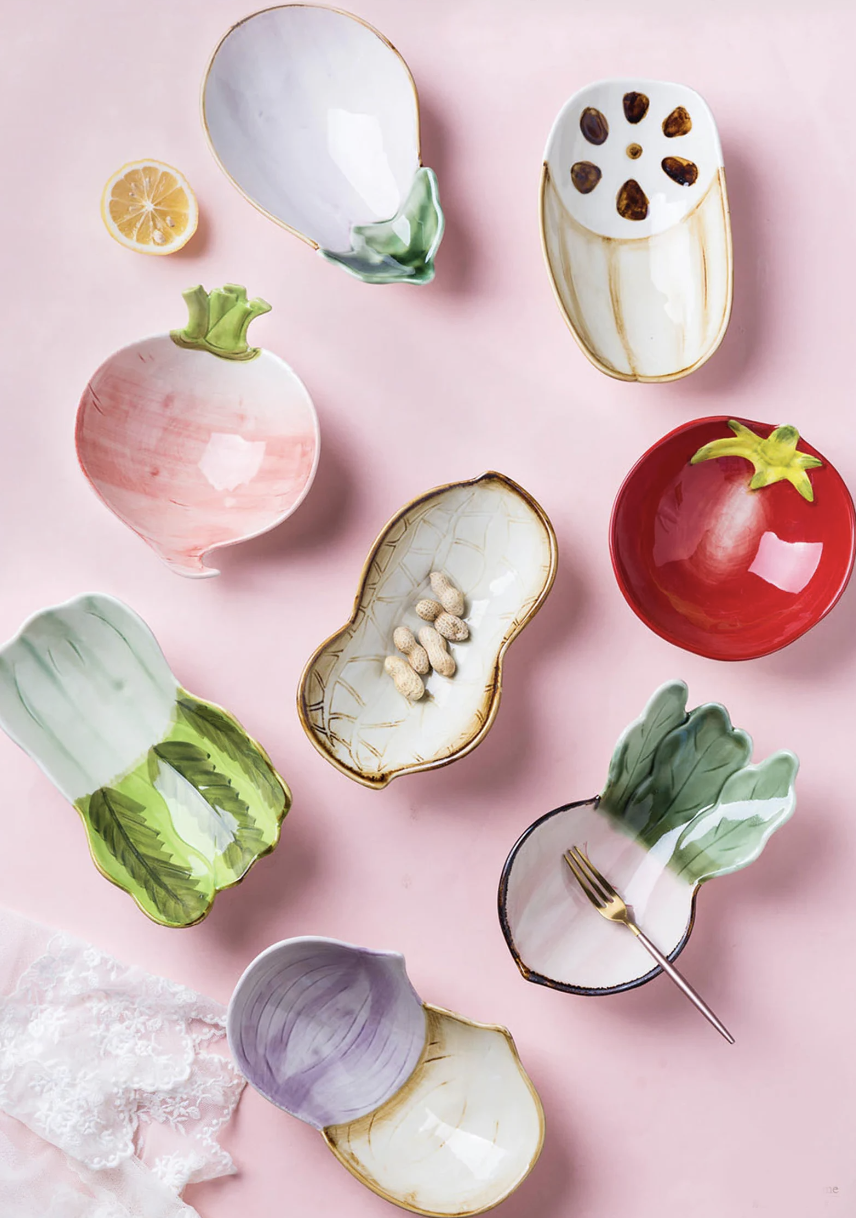 Ceramic Vegetable Plates in tomato, onion, radish bowls on pink table  (photo via Etsy)