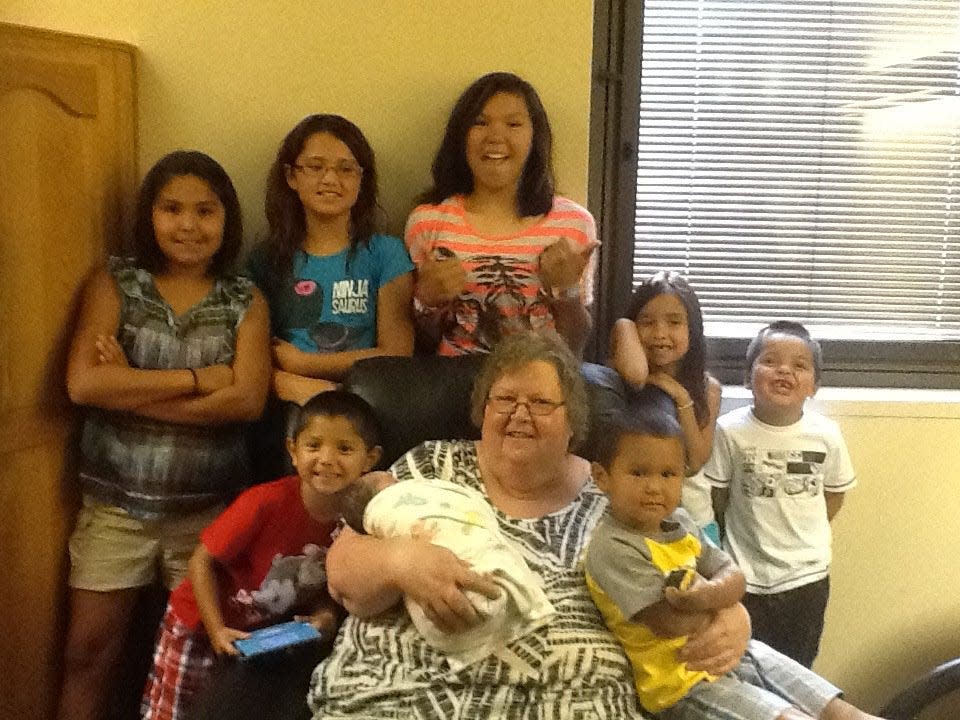 Marcella Yellow Hammer of McLaughlin, S.D., is shown in a family snapshot with her grandchildren. Yellow Hammer not only runs the Boys & Girls Club of Standing Rock, but also cares for some of her grandchildren at her home.