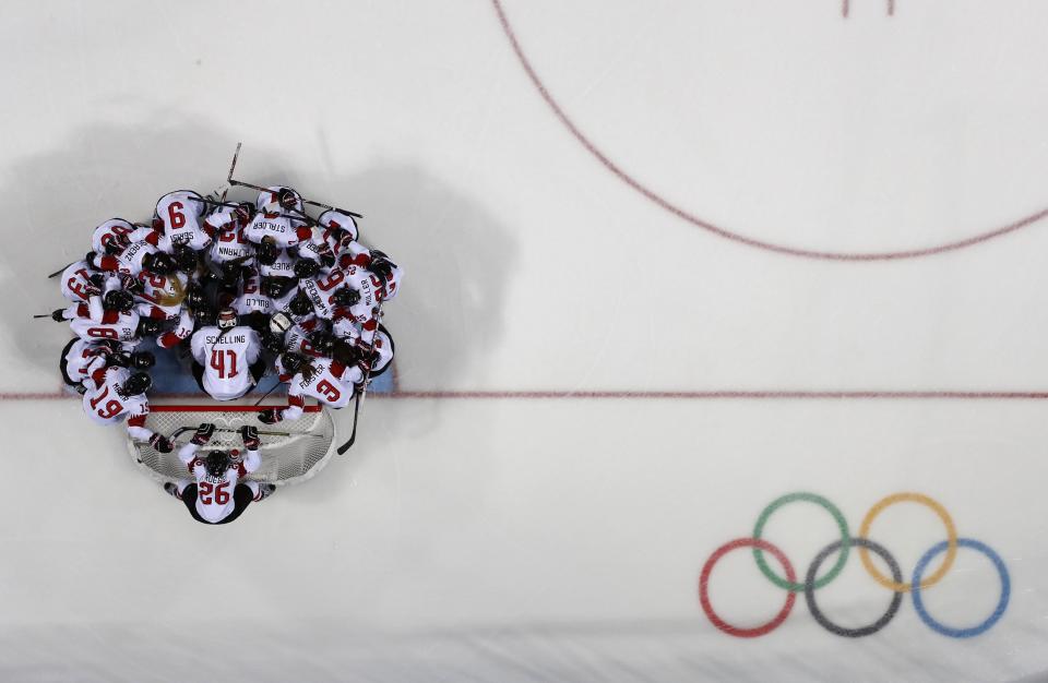 <p>Switzerland team gathers on the ice before their game against Sweden. REUTERS/Brian Snyder </p>