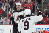 Arizona Coyotes center Nick Bjugstad is greeted by right wing Clayton Keller (9) after scoring during the third period of an NHL hockey game, Thursday, March 14, 2024, in Detroit. (AP Photo/Carlos Osorio)