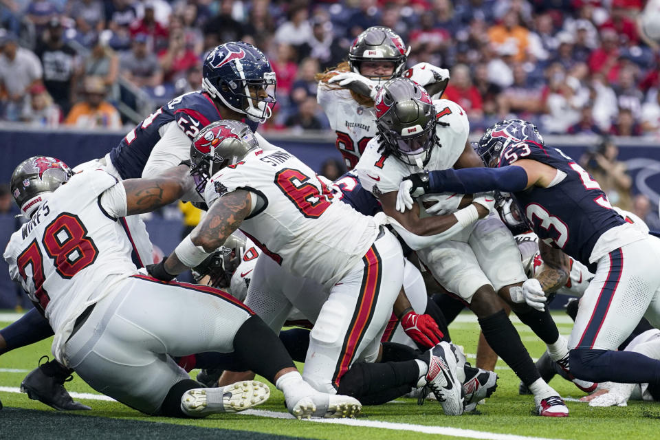 Tampa Bay Buccaneers running back Rachaad White (1) pushes through the tackle attempt of Houston Texans linebacker Blake Cashman (53) while scoring on a touchdown run during the second half of an NFL football game, Sunday, Nov. 5, 2023, in Houston. (AP Photo/Eric Christian Smith)
