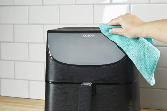wiping down the exterior of an air fryer