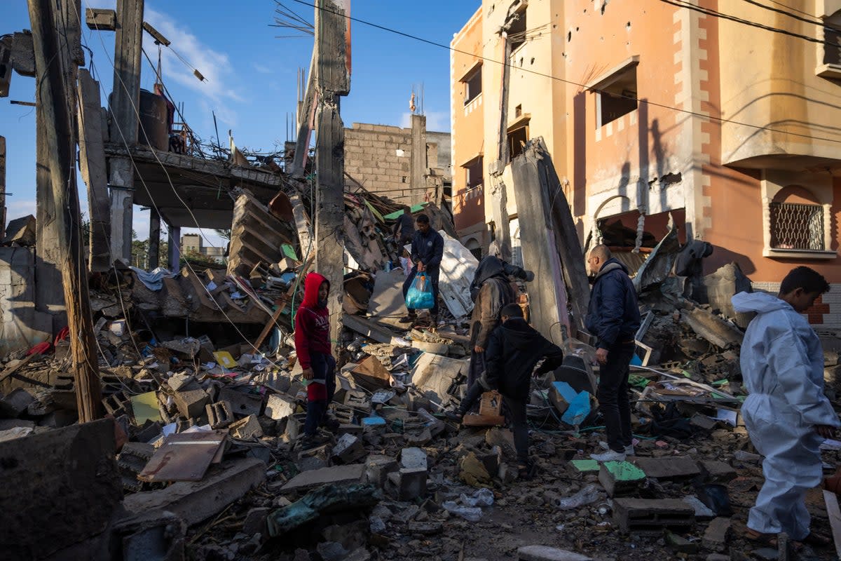 Palestinians look at the destruction after an Israeli strike in Rafah in the southern Gaza Strip (AP)