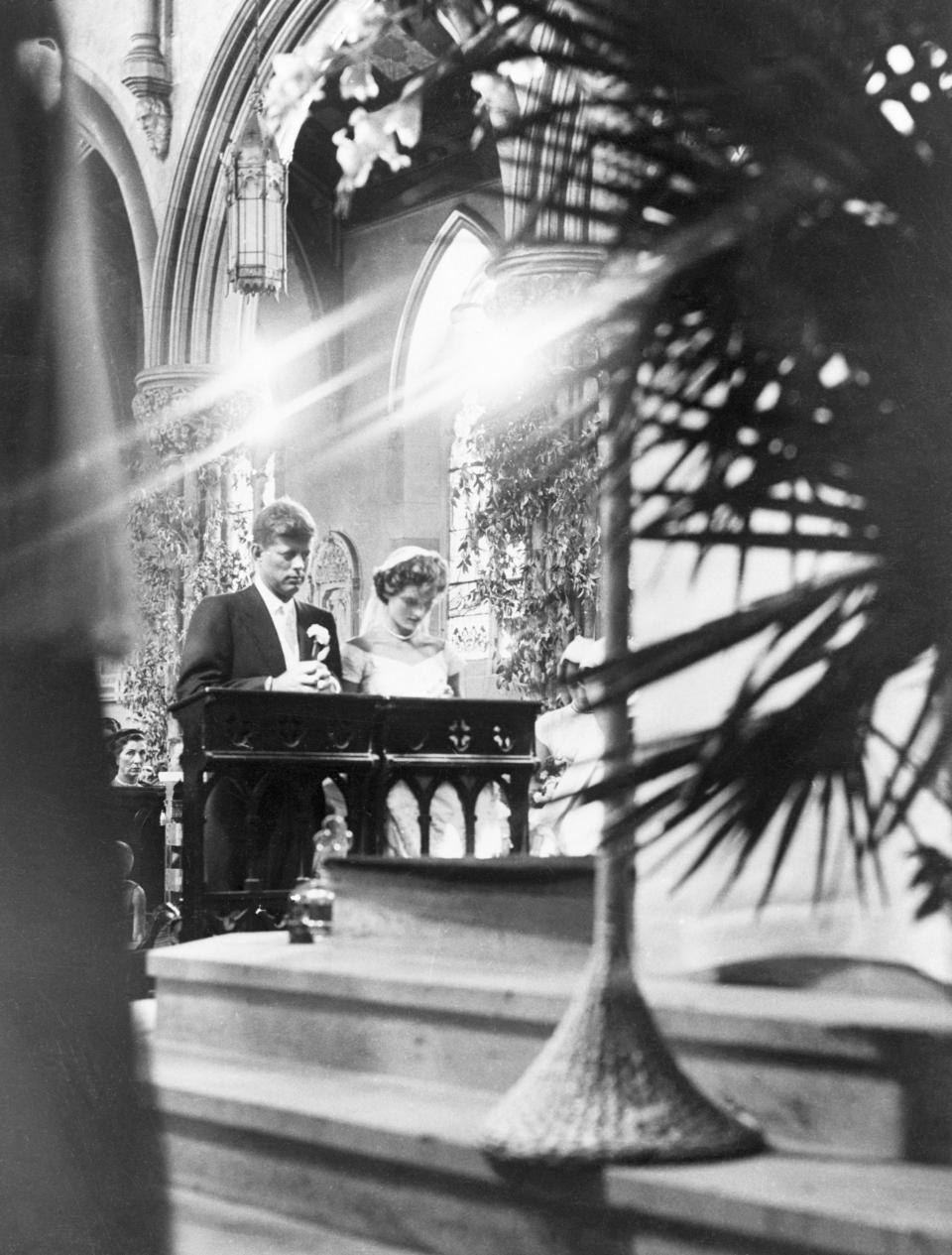 The couple kneel during the ceremony. (Photo: Bettmann via Getty Images)