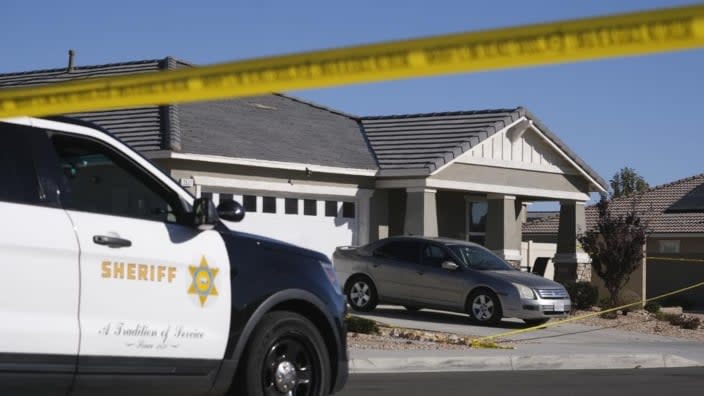Los Angeles County Sheriff deputies guard a home in Lancaster, Calif., where four children and their grandmother were found shot to death. The children’s father was arrested on suspicion of killing them. (Photo: Ringo H.W. Chiu/AP)