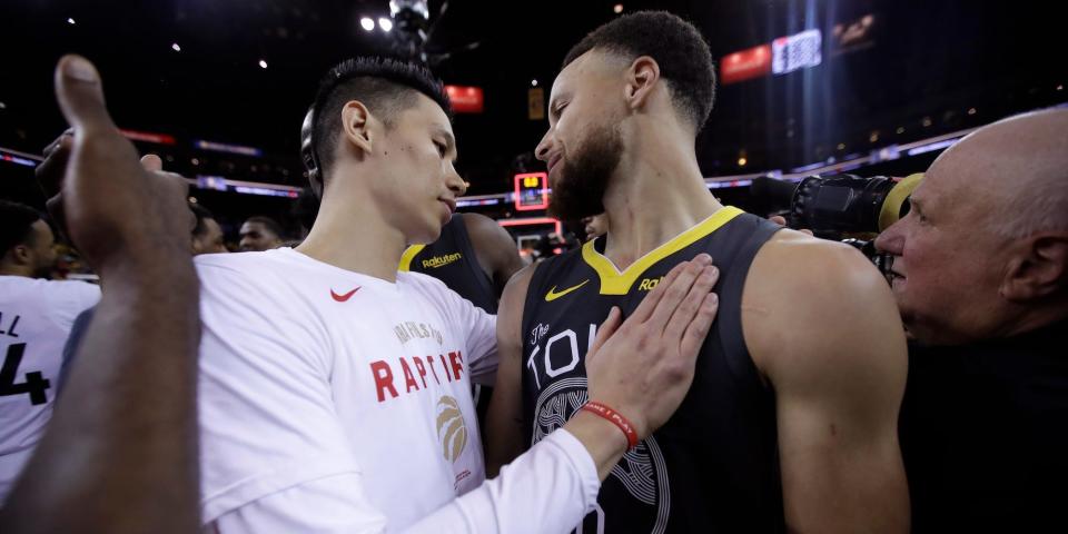 Jeremy Lin and Stephen Curry hug after the 2019 NBA Finals.