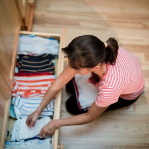 overhead view of woman organizing a drawer at home