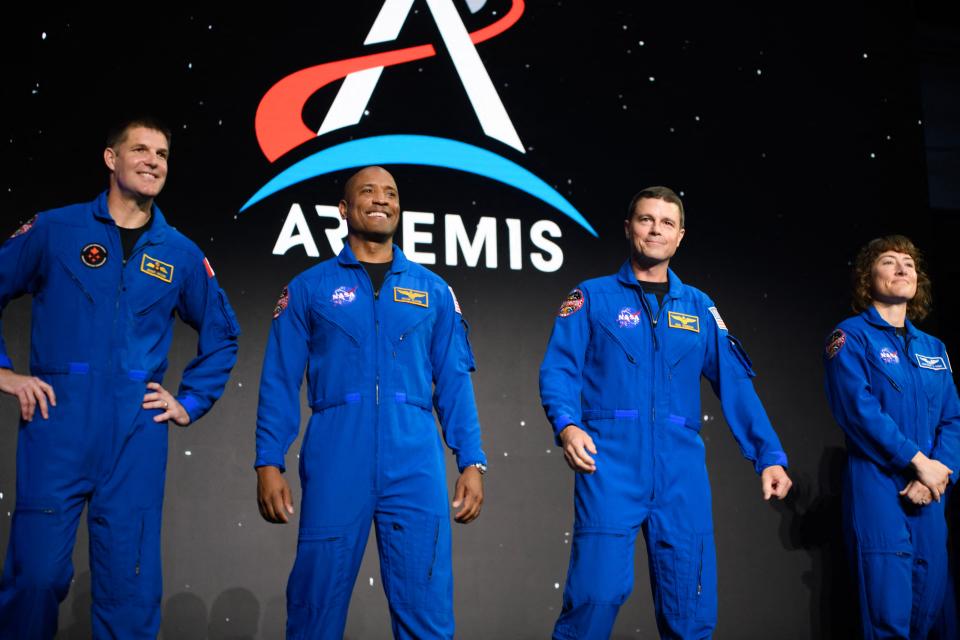 (L-R) Astronauts Jeremy Hansen, Victor Glover, Reid Wiseman and Christina Hammock Koch stand onstage after being selected for the Artemis II mission who will venture around the Moon during a news conference held by NASA and CSA at Ellington airport in Houston, Texas, on April 3, 2023. - Traveling aboard NASAs Orion spacecraft during Artemis II, the mission is the first crewed flight test on the agencys path to establishing a long-term scientific and human presence on the lunar surface. (Photo by Mark Felix / AFP) (Photo by MARK FELIX/AFP via Getty Images)