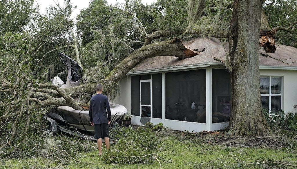 A homeowner surveys the damage wrought by Hurricane Ian in Valrico.