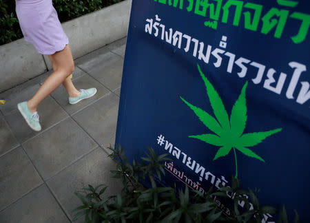 A woman walks pass near an election campaign poster in Bangkok, Thailand February 15, 2019. REUTERS/Soe Zeya Tun