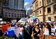 Protesters are seen taking part in The Global Strike 4 Climate rally in Brisbane