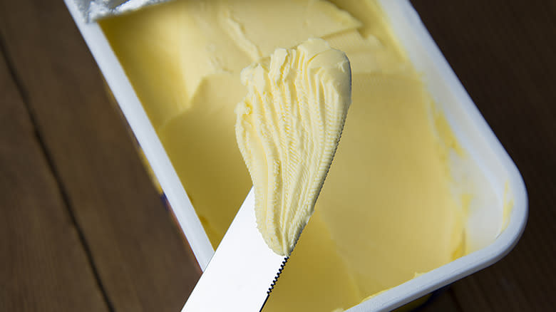 margarine tub with knife