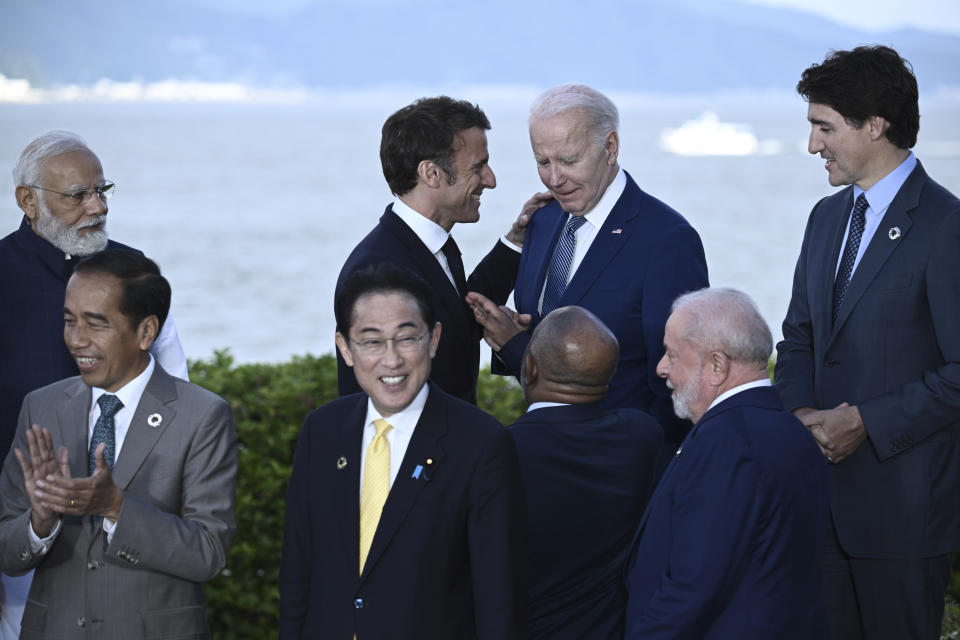 France's President Emmanuel Macron, top center left, speaks with U.S. President Joe Biden after a group photo of leaders of the G7 and invited countries during the G7 Leaders' Summit in Hiroshima, western Japan, Saturday, May 20, 2023. (Brendan Smialowski/Pool Photo via AP)