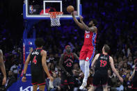 Philadelphia 76ers' Joel Embiid (21) goes up to shoot against Toronto Raptors' Scottie Barnes (4), Pascal Siakam (43) and Jakob Poeltl (19) during the first half of an NBA basketball game, Friday, March 31, 2023, in Philadelphia. (AP Photo/Matt Rourke)