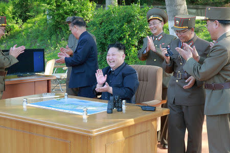 FILE PHOTO : North Korean leader Kim Jong Un inspects the intermediate-range ballistic missile Pukguksong-2's launch test with Ri Pyong Chol (2nd L in black uniform) and Jang Chang Ha (R) in this undated photo released by North Korea's Korean Central News Agency (KCNA) May 22, 2017. REUTERS/KCNA/File Photo