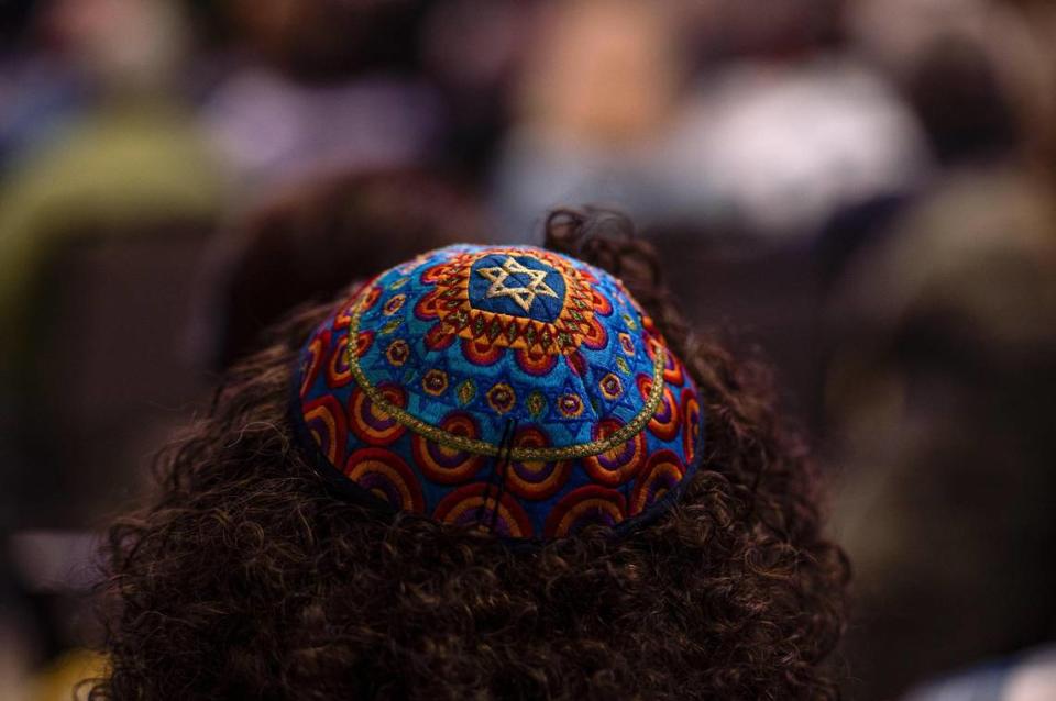 A colorful yarmulke sits on top of Andre Delgado-Ogli’s head on Monday, Oct. 9, 2023, The Temple, Congregation B’nai Jehudah in Overland Park. Congregants were led in prayer by local Rabbi’s and members of Kansas City’s Jewish community.