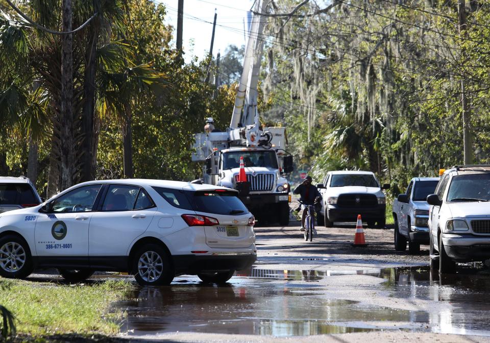 Daytona Beach Public Works employee checks out the progress on Fulton Street in Daytona Beach's Midtown nieghborhood, an area hard-hit by Tropical Storm Ian. Residents on Fulton Street were still waiting on Sunday for their power to be restored.