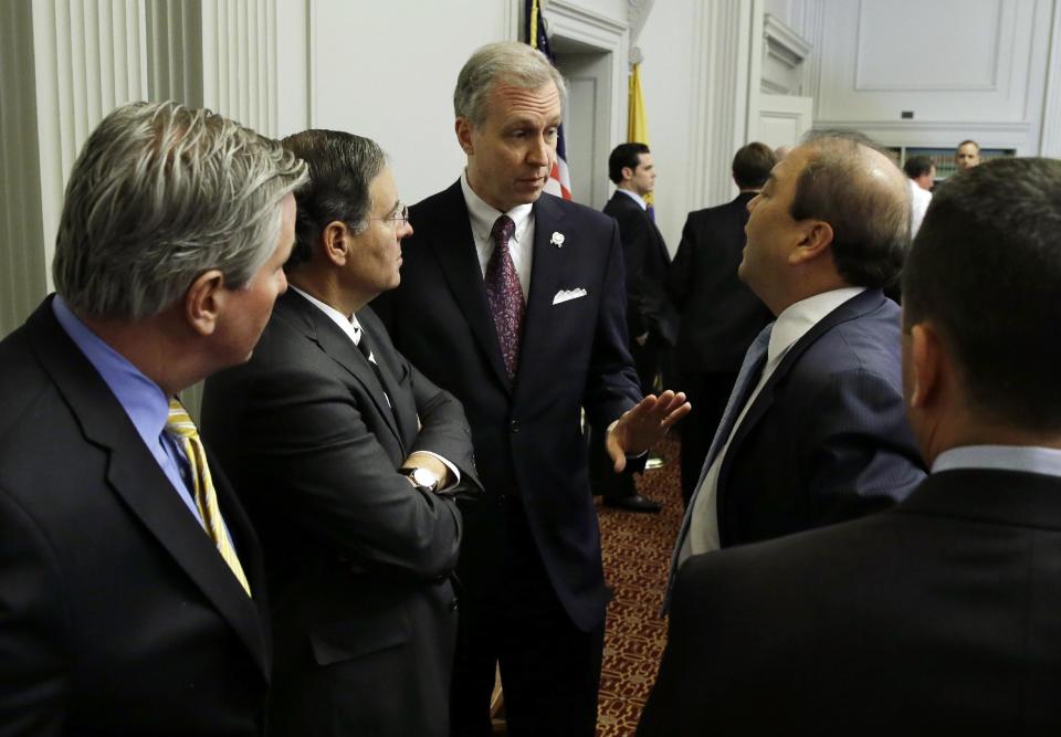 New Jersey Assemblyman John S. Wisniewski, center, D-Sayreville, N.J., co-chair of a joint bipartisan committee of members of the New Jersey Senate and Assembly, talks with Republican Assembly Leader, Jon M. Bramnick, second left, R-Westfield, N.J., and Sen. Kevin J. O'Toole, R-Wayne, N.J., second from right, and others before a meeting at the Statehouse in Trenton, N.J., Monday, Feb. 10, 2014. More subpoenas are expected to be issued by a New Jersey legislative committee investigating a plot to create gridlock by blocking lanes near the George Washington Bridge. (AP Photo/Mel Evans)