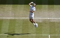 Roger Federer of Switzerland hits a return during his men's singles final tennis match against Novak Djokovic of Serbia at the Wimbledon Tennis Championships, in London July 6, 2014. REUTERS/Toby Melville