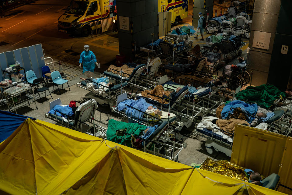 HONG KONG, CHINA - FEBRUARY 16: Patients lay in beds as they wait at a temporary holding area outside Caritas Medical Centre on February 16, 2022 in Hong Kong, China.  Health authorities confirm a new daily record of 4285 infections while near a record high of 7000 people tested preliminary positive. At least 10,000 infected people are waiting to be admitted to Hong Kong hospitals as cases overwhelm the public health care system.(Photo by Anthony Kwan/Getty Images)