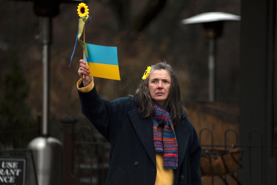 Olga Vannucci waves signs in support of Ukraine by New Hope-Lambertville bridge in Lambertville on Wednesday, March 9, 2022. Several New Hope and Lambertville organizations came together to stand in solidarity with Ukrainian people.