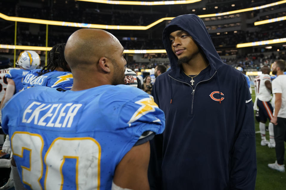 Los Angeles Chargers running back Austin Ekeler, left, talks with injured Chicago Bears quarterback Justin Fields after the Chargers defeated the Bears 30-13 in an NFL football game Sunday, Oct. 29, 2023, in Inglewood, Calif. (AP Photo/Ryan Sun)