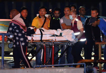 Police coast guards escort a Chinese tourist rescued after their boat sank off the coast of Borneo, at a port in Kota Kinabalu, Malaysia early January 30, 2017. REUTERS/Stringer