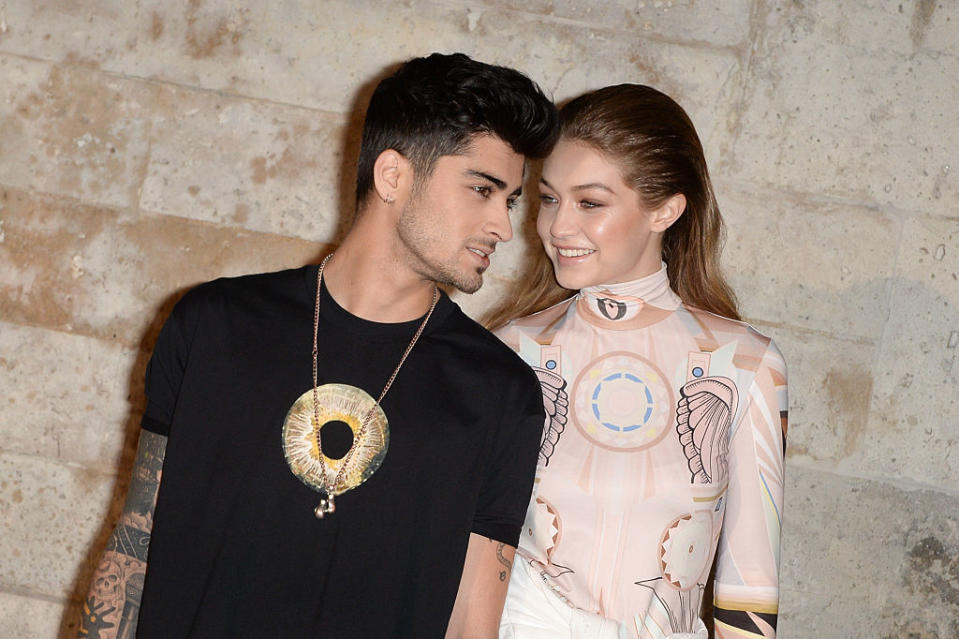 Gigi Hadid and Zayn Malik are reportedly expecting their first baby, pictured here at Paris Fashion Week in October, 2016 (Getty Images)