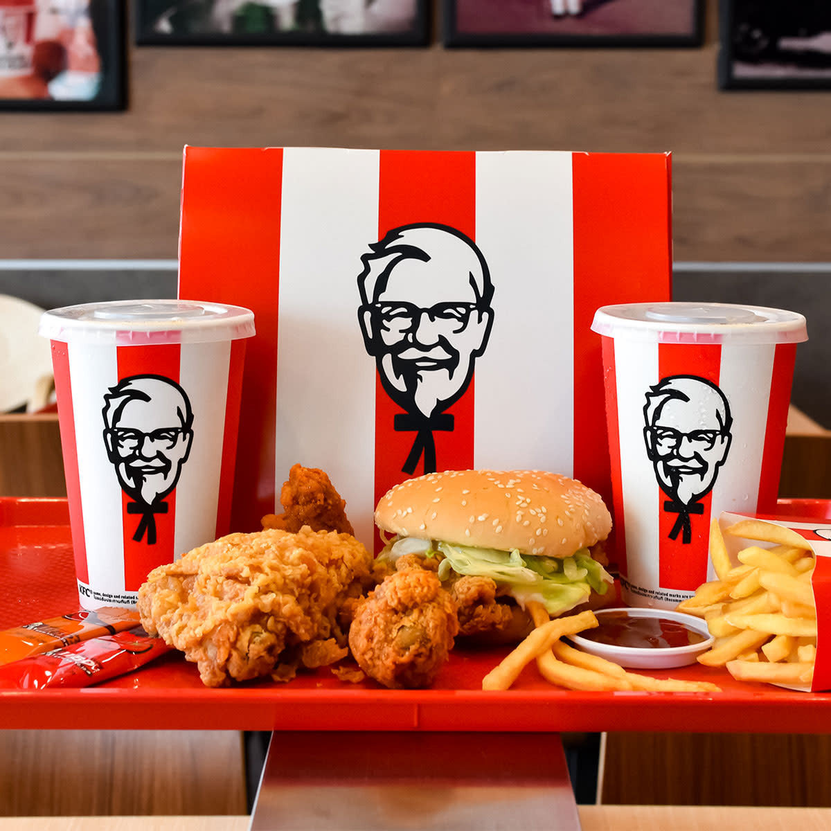 KFC meal with two drinks, sandwich, fries, and more