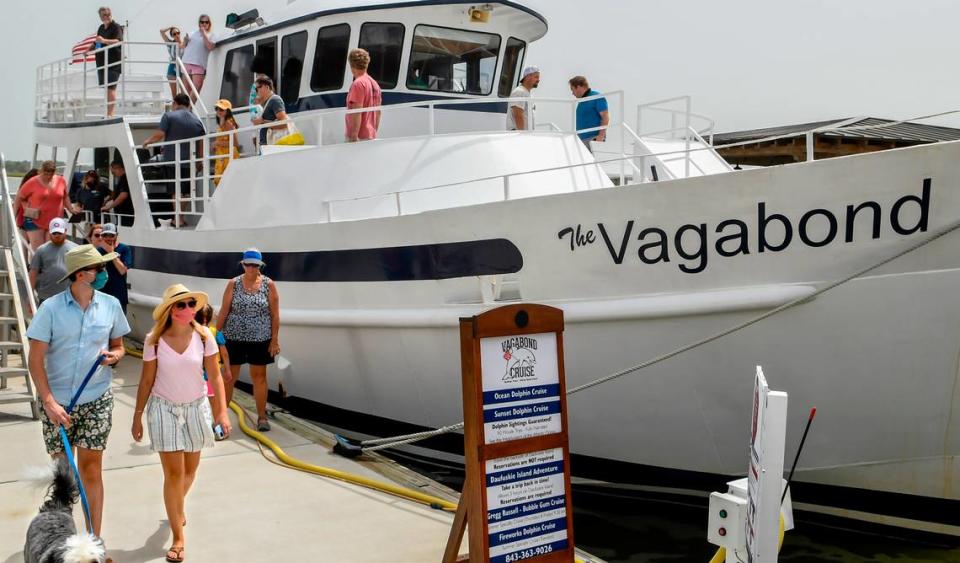 Before the mandatory mask requirement, two guests wearing face coverings disembark from The Vagabond Cruise on Saturday, June 27, 2020 at Harbour Town in Sea Pines on Hilton Head Island after a sight seeing cruise.