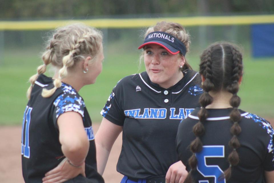 Inland Lakes' Maggie Grant (middle) interacts with fellow seniors Lakyn Thompson (left) and Erica Taglauer (5) during a game from this past season.