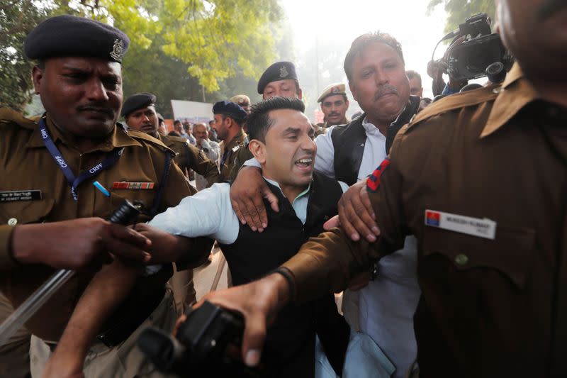 Police detain a demonstrator during a protest against the Citizenship Amendment Bill, a bill that seeks to give citizenship to religious minorities persecuted in neighbouring Muslim countries, in New Delhi