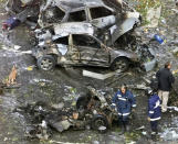 FILE - In this Nov. 6, 2001 file photo, firefighters work at the scene of a car bomb in Madrid. Josu Urrutikoetxea, the last known chief of ETA, the now-extinct Basque separatist militant group, goes on trial Monday Oct. 19, 2020 in Paris for terrorism charges that he deems “absurd” because of his role in ending a conflict that claimed hundreds of lives and terrorized Spain for half a century. (AP Photo/Paul White, File)