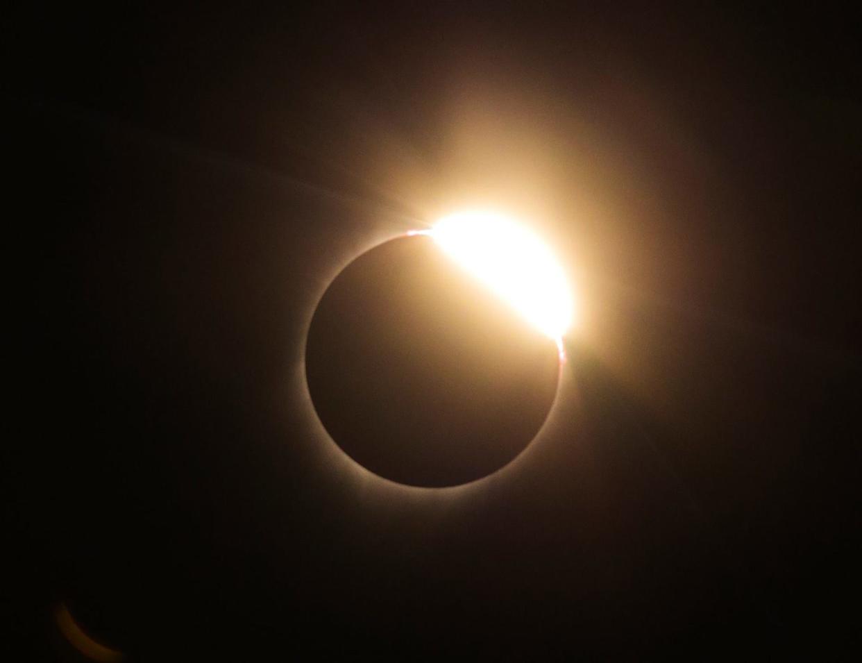 At the end of a total solar eclipse in 2017, the sun begins to emerge from behind the moon in this view from Oregon. A total eclipse will be seen by millions of Americans from Texas to Maine on April 8.