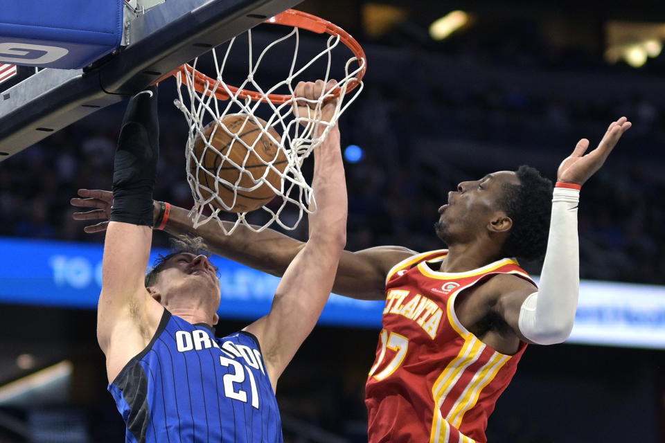 Orlando Magic center Moritz Wagner (21) dunks in front of Atlanta Hawks forward Onyeka Okongwu (17) during the second half of an NBA basketball game Wednesday, Nov. 30, 2022, in Orlando, Fla. (AP Photo/Phelan M. Ebenhack)