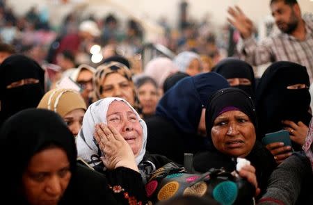 A woman cries as she asks for a travel permit to cross into Egypt through the Rafah border crossing after it was opened for two days by Egyptian authorities, in the southern Gaza Strip May 11, 2016. REUTERS/Suhaib Salem