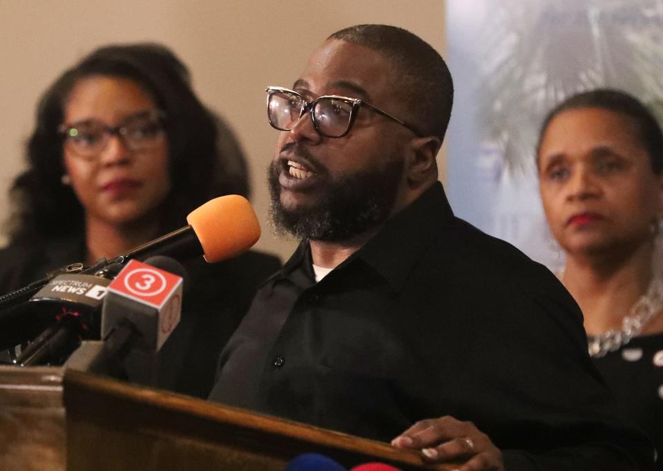 The Rev. Raymond Greene Jr., executive director of  The Freedom BLOC, speaks as U.S. Rep. Emilia Sykes and Teresa R. LeGrair, president and CEO of Akron Urban League, listen during a press conference Monday at St. Ashworth Temple Church of God in Christ.