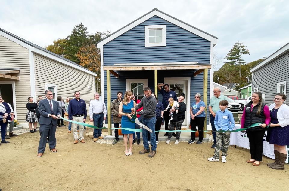 Design-build duo John and Maggie Randolph cut the ribbon to officially open the Cottages at Back River Road on Thursday morning in Dover.