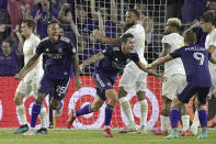 Orlando City defender Kyle Smith, center, celebrates after scoring a goal as defender Antonio Carlos (25) and forward Chris Mueller (9) come to congratulate him during the first half of an MLS soccer match against Atlanta United, Friday, July 30, 2021, in Orlando, Fla. (Phelan M. Ebenhack/Orlando Sentinel via AP)