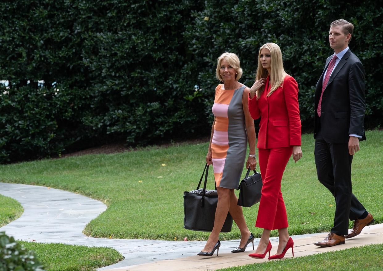 US Education Secretary Betsy DeVos (L), Ivanka Trump (C) and Eric Trump walk to board Marine One at the White House in Washington, DC, on July 31, 2018 as US President Donald Trump departs for Florida. (Photo by NICHOLAS KAMM / AFP)        (Photo credit should read NICHOLAS KAMM/AFP via Getty Images)