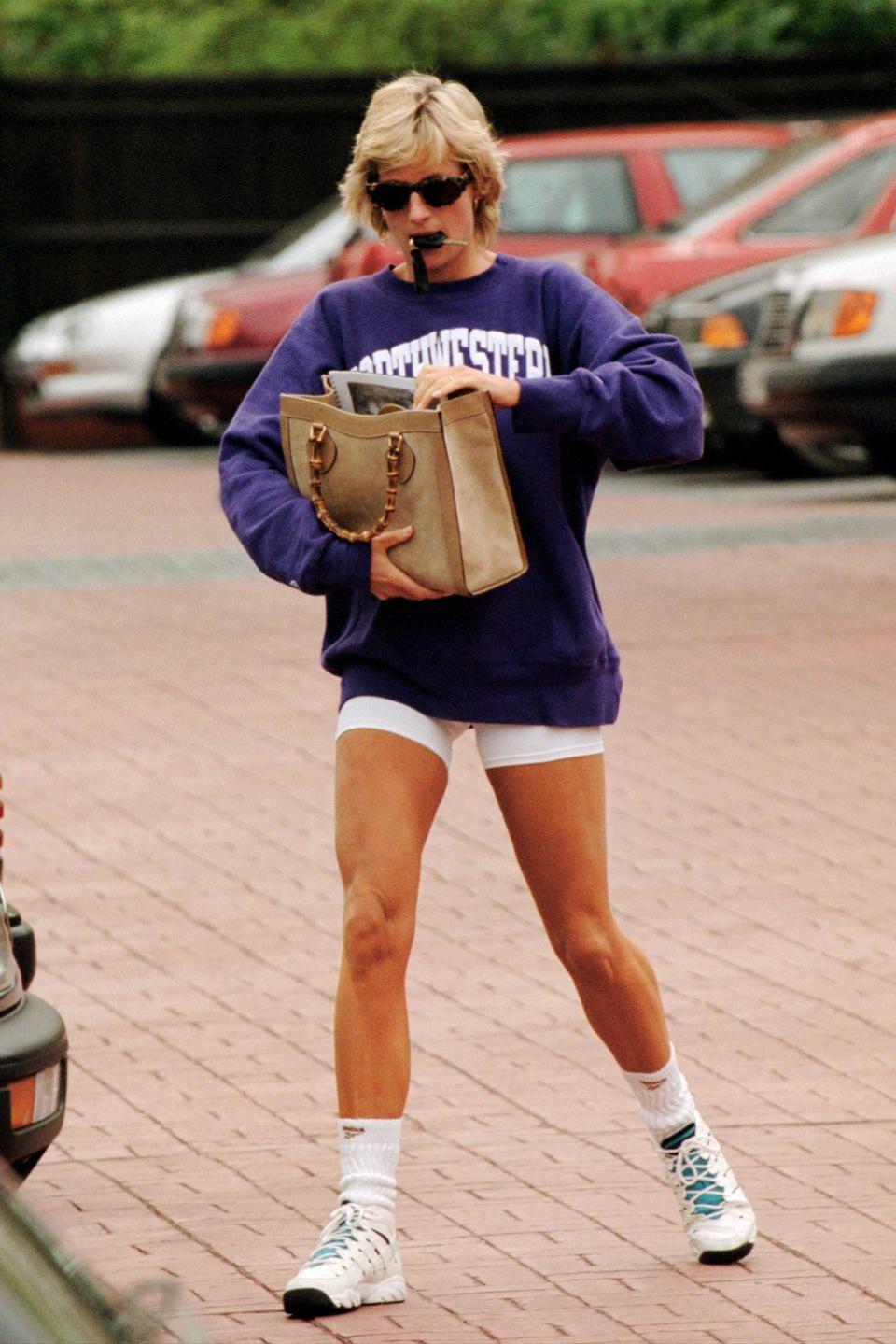 <p>Continuing her penchant for collegiate sweatshirts, Diana represented another American university, sporting a Northwestern sweatshirt and white shorts. Adding some luxury, Diana accessorized with a Gucci tote. </p>