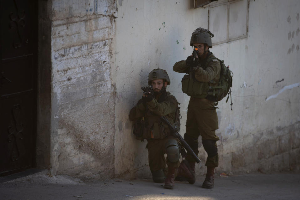Israeli troops patrol the streets and search houses during an army operation following a stone throwing attack on an Israeli driver near the Allon Moreh Jewish settlement, at the West Bank village of Salem, near Nablus, Monday, Aug. 23, 2021. (AP Photo/Majdi Mohammed)