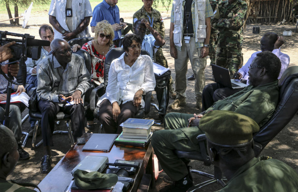 In this photo taken Tuesday, April 29, 2014 and released by the United Nations Mission in South Sudan (UNMISS) on Wednesday, April 30, 2014, United Nations High Commissioner for Human Rights Navi Pillay, center, accompanied by Special Adviser on the Prevention of Genocide Adama Dieng, left, meets with South Sudan's former Vice President and now rebel leader Riek Machar, right, at an undisclosed location in South Sudan. The U.N.'s top official for human rights told a news conference in South Sudan's capital Juba on Wednesday that the country is on the verge of catastrophe because of a deadly mix of recrimination, hate speech and revenge killings since December and that she is appalled by the apparent lack of concern by leaders in South Sudan over the risk of a potential famine. (AP Photo/UNMISS)