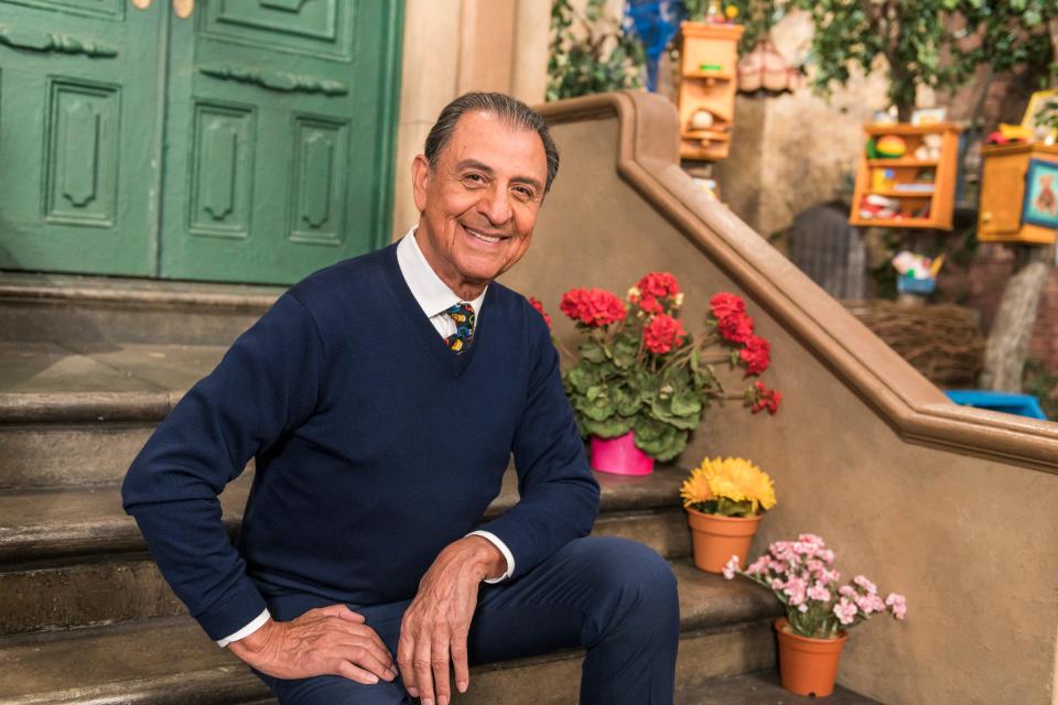 In this photo provided by Sesame Workshop, Emilio Delgado poses for a picture at Kaufman Astoria Studios while filming the 50th season of "Sesame Street," in October 2018. Delgado, the actor and singer who for 45 years was a warm and familiar presence in children's lives and a rare Latino face on American television as fix-it shop owner Luis on “Sesame Street,” died Thursday, March 10, 2022. He was 81. 