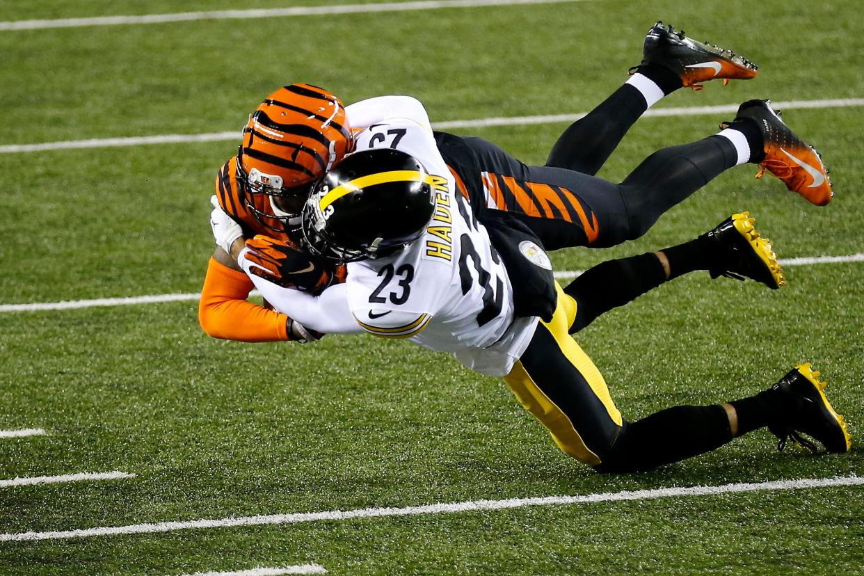 Pittsburgh Steelers cornerback Joe Haden (23) throws down Cincinnati Bengals wide receiver Tee Higgins (85) after a catch in the first quarter of the NFL 15 game between the Cincinnati Bengals and the Pittsburgh Steelers at Paul Brown Stadium in downtown Cincinnati on Monday, Dec. 21, 2020. The Bengals led 17-0 at halftime. 