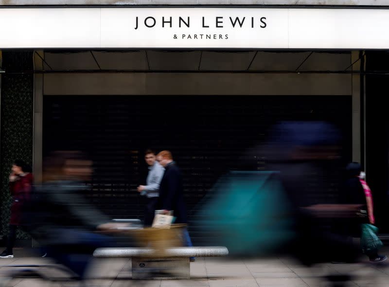 People walk past a temporarily closed John Lewis department store on Oxford Street in London