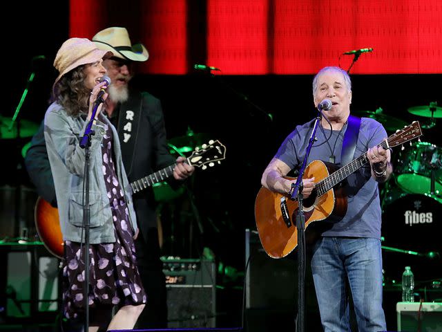 <p>Gary Miller/Getty</p> Edie Brickell and Paul Simon perform in concert during the "Texas Strong: Hurricane Harvey Can't Mess With Texas" benefit in September 2017 in Austin, Texas.