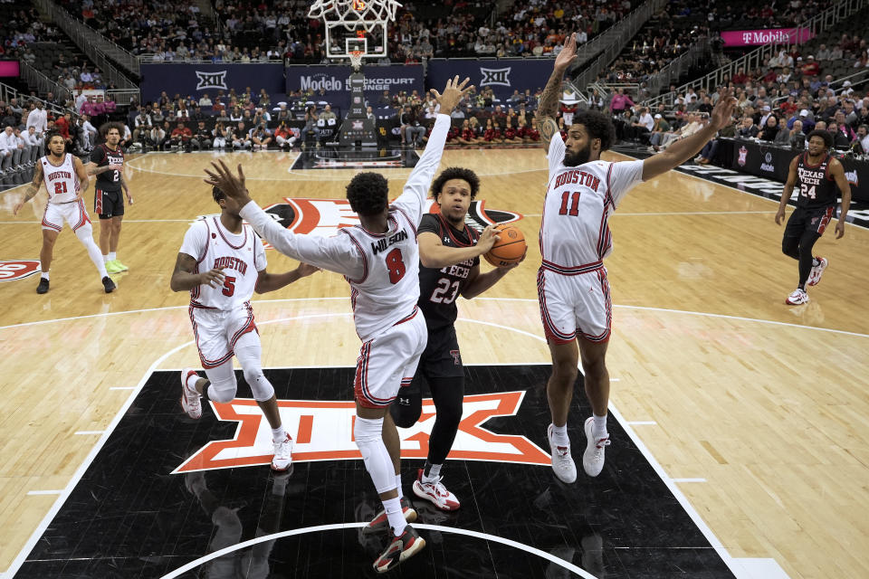 Texas Tech forward Eemeli Yalaho (23) tries to get past Houston guard Mylik Wilson (8) during the first half of an NCAA college basketball game in the semifinal round of the Big 12 Conference tournament, Friday, March 15, 2024, in Kansas City, Mo. (AP Photo/Charlie Riedel)
